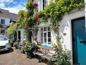 a bench sitting outside of a building with flowers at 1 Bed in Presteigne oc-55285 in Presteigne +12 photos