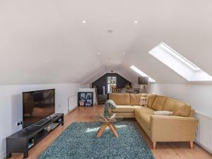 a living room with a couch and a tv at 2 Bed in Cardigan oc-83919 in Cilgerran