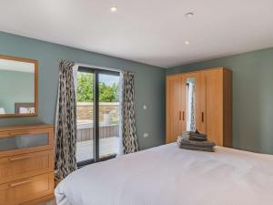 a bedroom with a large bed and a window at 2 Bed in Cardigan oc-83919 in Cilgerran +14 photos