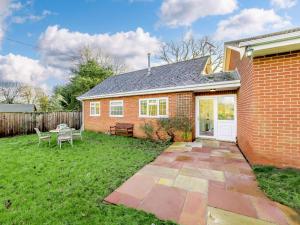 a brick house with a yard with a patio at 2 Bed in Wrexham oc-43916 in Overton