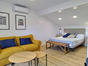 a bedroom with a bed and a couch and a table at Alojamientos arans in La Cañiza