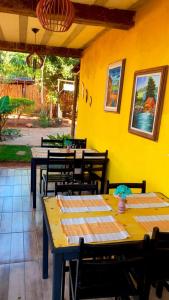 a group of tables and chairs in a restaurant at Pousada Raízes do Cipó in Serra do Cipo