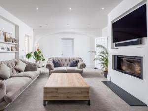 a living room with two couches and a fireplace at 5 Bed in Bude oc-85698 in Poughill