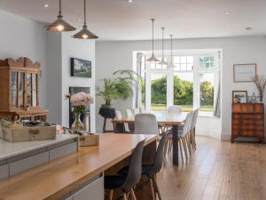 a kitchen and dining room with a table and chairs at 5 Bed in Bude oc-85698 in Poughill