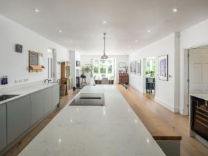 an open kitchen with white walls and wooden floors at 5 Bed in Bude oc-85698 in Poughill