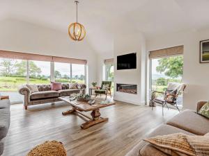 a living room with a couch and a table at 5 Bed in Denbigh oc-86009 in Llandyrnog