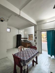 a dining room with a table and chairs in a room at Green leaf homes in North Lakhimpur