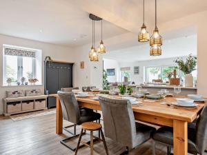 a kitchen and dining room with a wooden table and chairs at 5 Bed in Denbigh oc-86009 in Llandyrnog