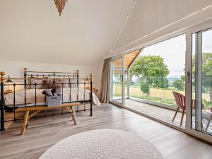 a bedroom with a bed and a large window at 5 Bed in Denbigh oc-86009 in Llandyrnog +67 photos