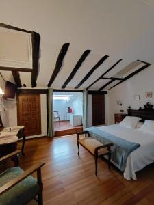 a bedroom with a bed and a room with a table at Casona De Linares in Selaya