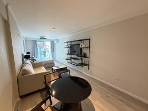 a living room with a couch and a table at Deco Recoleta in Buenos Aires