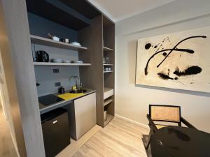 a kitchen with a sink and a counter in a room at Deco Recoleta in Buenos Aires +13 photos