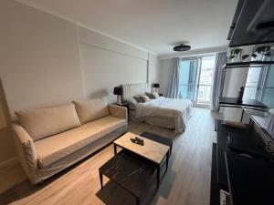 a living room with a couch and a bed at Deco Recoleta in Buenos Aires