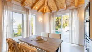 a kitchen and dining room with a table and chairs at Villa Silvana by Villas Guide in Blato