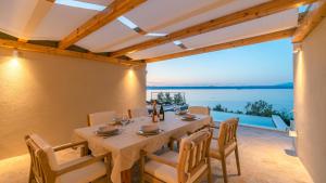 a dining room with a table and a view of the ocean at Villa Silvana by Villas Guide in Blato