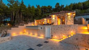 a house with lights on the side of it at Villa Silvana by Villas Guide in Blato