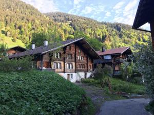 a large wooden house on a hill in the mountains at Swiss Mountain Chalet in Saxeten
