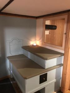 a kitchen with white cabinets and a counter top at Swiss Mountain Chalet in Saxeten +29 photos