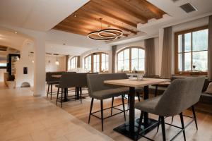 a dining room with a table and chairs at Hotel Kristall in Grossarl
