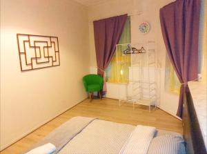a bedroom with a bed and a green chair at Central Simple Cambridge stay in Cambridge