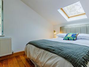 a bedroom with a large bed with a skylight at 6 Bed in Abergele oc-91054 in Llanddulas
