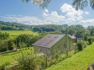 an old stone house on a hill with a green field at 6 Bed in Abergele oc-91054 in Llanddulas