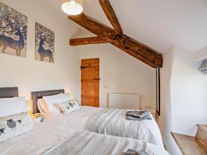 two beds in a bedroom with wooden beams at 6 Bed in Harlech oc-91546 in Harlech