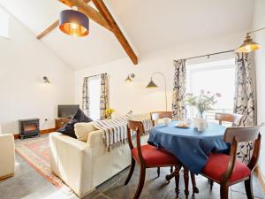 a living room with a table and a couch at 6 Bed in Harlech oc-91546 in Harlech