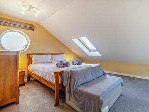 a bedroom with a bed and a skylight at 2 Bed in Cromer oc-29556 in Cromer +13 photos
