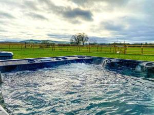 a large pool of water in a field at 14 Bed in Welshpool oc-90568 in Berriew