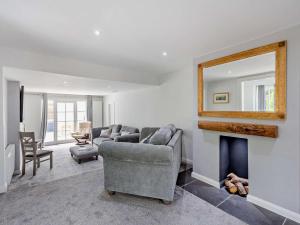 a living room with a couch and a fireplace at 4 Bed in Beaumaris oc-94501 in Llanddona