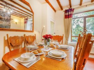 a dining room with a wooden table and chairs at 3 Bed in Corwen oc-90459 in Corwen