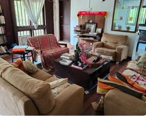 a living room with couches and a coffee table at Readers heaven in Ampang