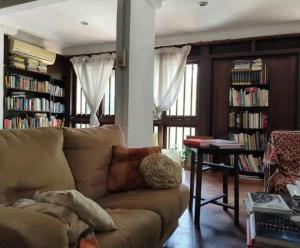 a living room with a couch and a table with books at Readers heaven in Ampang