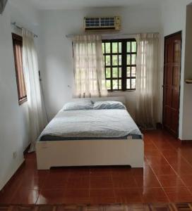 a bedroom with a bed in a room with a window at Readers heaven in Ampang