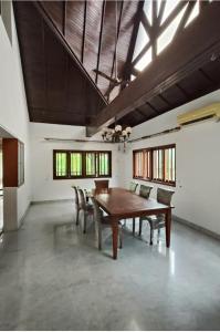 a large dining room with a wooden table and chairs at Readers heaven in Ampang