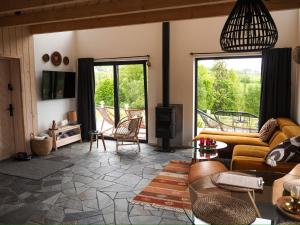 a living room with a couch and a tv at Owczarnia Tatry in Bukowina Tatrzańska