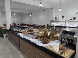 a buffet line with various types of bread and pastries at Lazgi Boutique & Spa Hotel in Khiva