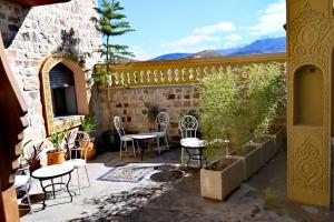 a patio with chairs and tables in a building at Bihi Lodge in Tahannout