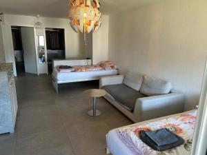 a living room with two beds and a couch at HANNA Apartment in Interlaken