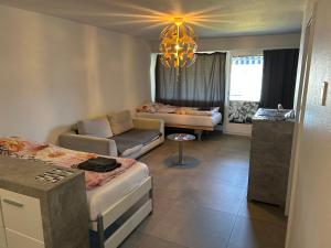 a living room with a bed and a couch at HANNA Apartment in Interlaken