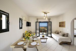 a living room with a couch and a table at Kefalonian Oneira Villas in Mousata +41 photos