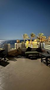 a resort with benches and a view of the ocean at Eel garden paradise dahab in Dahab