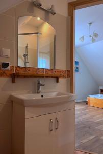 a bathroom with a sink and a mirror at SKiPER Dębki in Dębki +120 photos