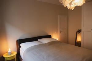 a bedroom with a bed with two lights on it at JETHON Appartement in der Gasse 2 in Grimschleben