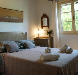 a bedroom with a large bed with towels on it at Aphrodite's Coast Retreat House! in Galaxidi +52 photos