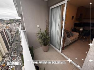 a balcony of a apartment with a couch at Studio Diamante no CENTRO com piscina, academia e opção de vaga privativa in Juiz de Fora
