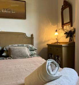 a bedroom with a bed with a towel on it at Aphrodite's Coast Retreat House! in Galaxidi