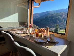 a breakfast table with a view of a mountain at Daislehof in Münstertal