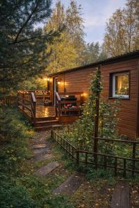 a log cabin with a porch and a fence at Miodowy Zakątek Całoroczne Domki i Pokoje przy Suntago, Deepspot, Pyszne Śniadania, Grill in Mszczonów